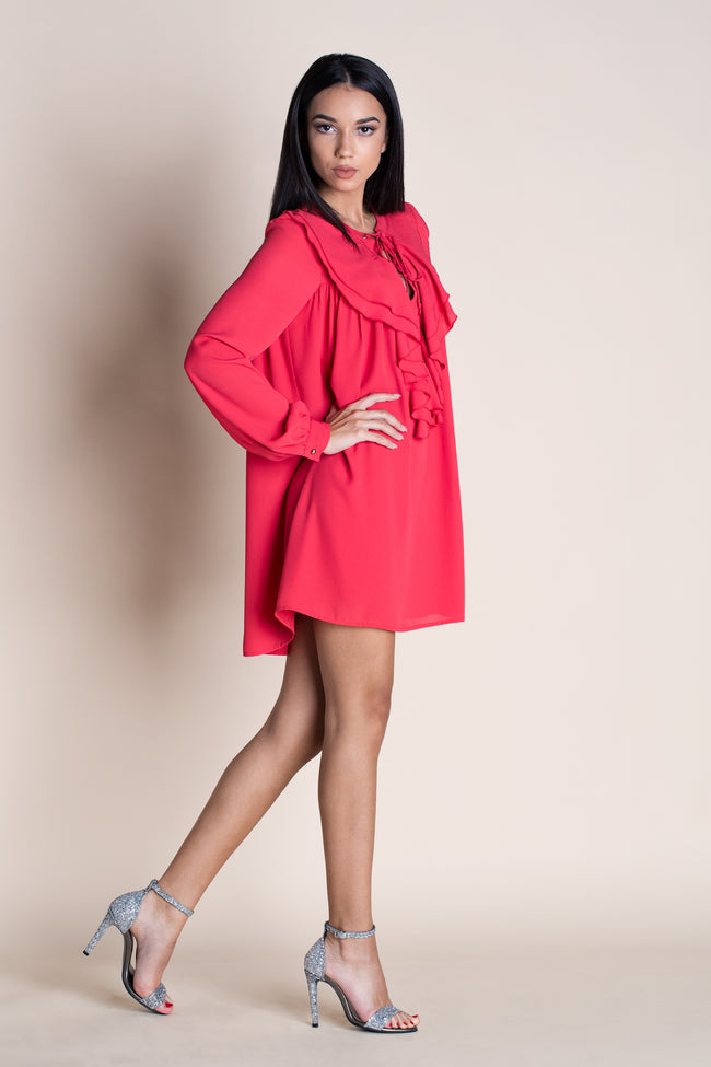 side view of a woman posing in a red babydoll dress