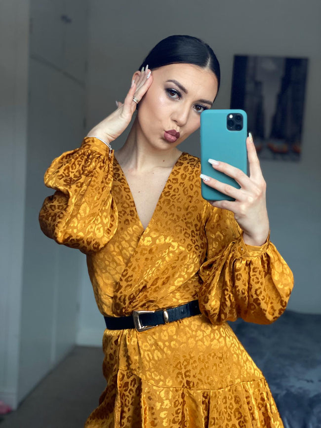 woman posing with a golden diy sewn wrap dress pattern