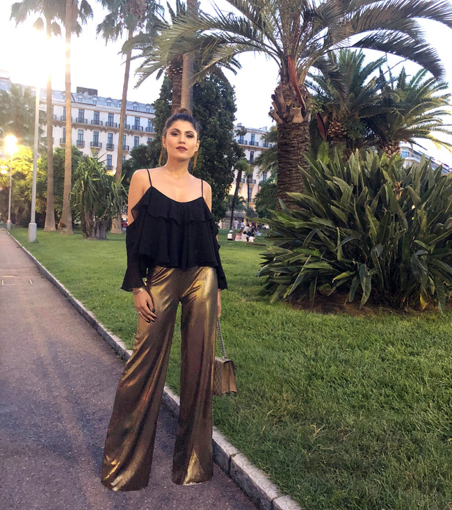woman posing in a pair of golg high waist pants pattern diy made and a black top