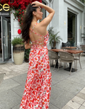 girl posing in a red floral backless dress pattern