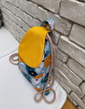 a flowery fabric pipe cord pouch on a pillow in a restaurant