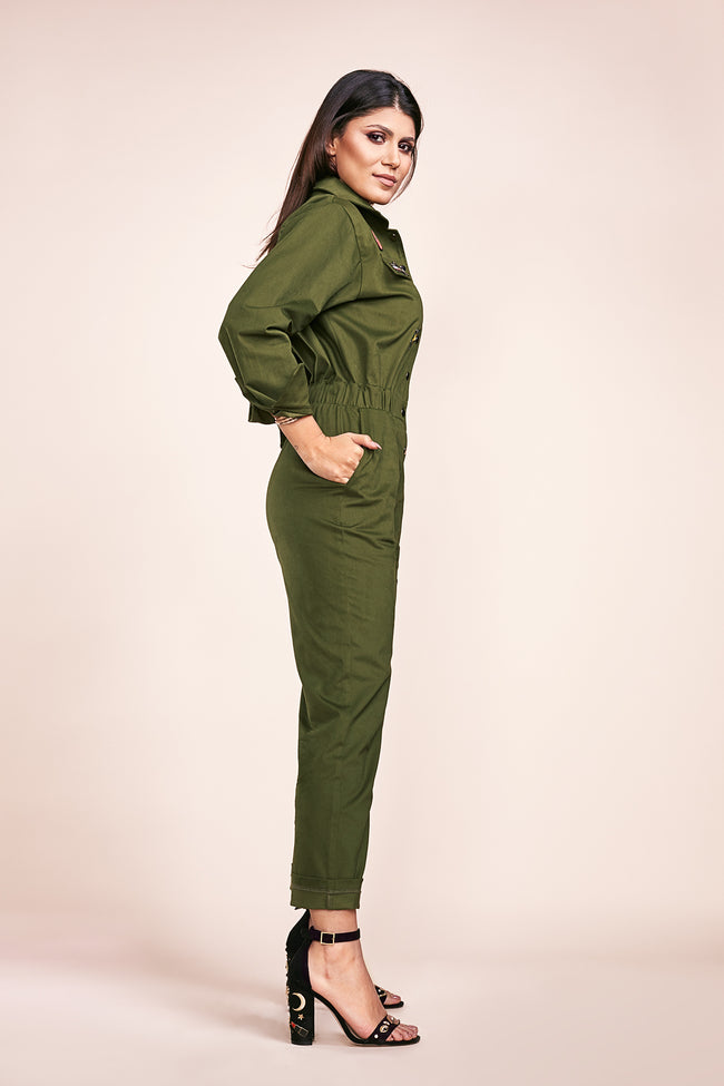 side view of a woman posing in a military jumpsuit pattern