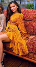 woman wearing a golden diy sewn asymmetrical wrap dress pattern