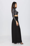 side view of a woman posing in a crop top and a diy sewn pair of black palazzo pants pattern