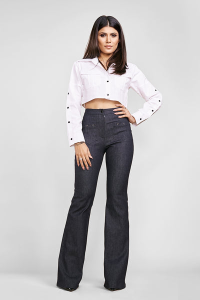 woman posing in a white crop top sewing pattern and jeans