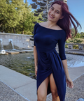 woman smiling and posing in a off the shoulder dress pattern