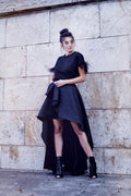 woman against a wall wearing a black skirt sewing pattern and a black tshirt