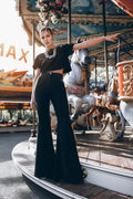 woman wearing black bell bottom flare pants