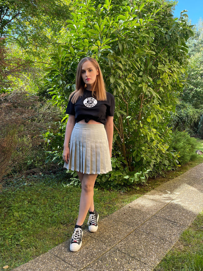 woman posing in a pleated tennis skirt