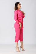 side view of a woman posing in a pink jumpsuit pattern