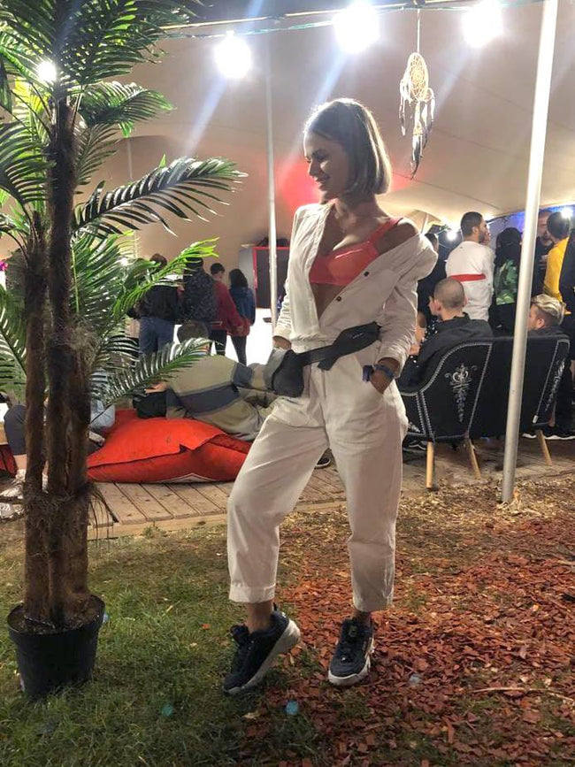 woman at a festival in a white denim jumpsuit pattern