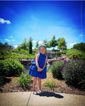 little girl in a blue layered dress