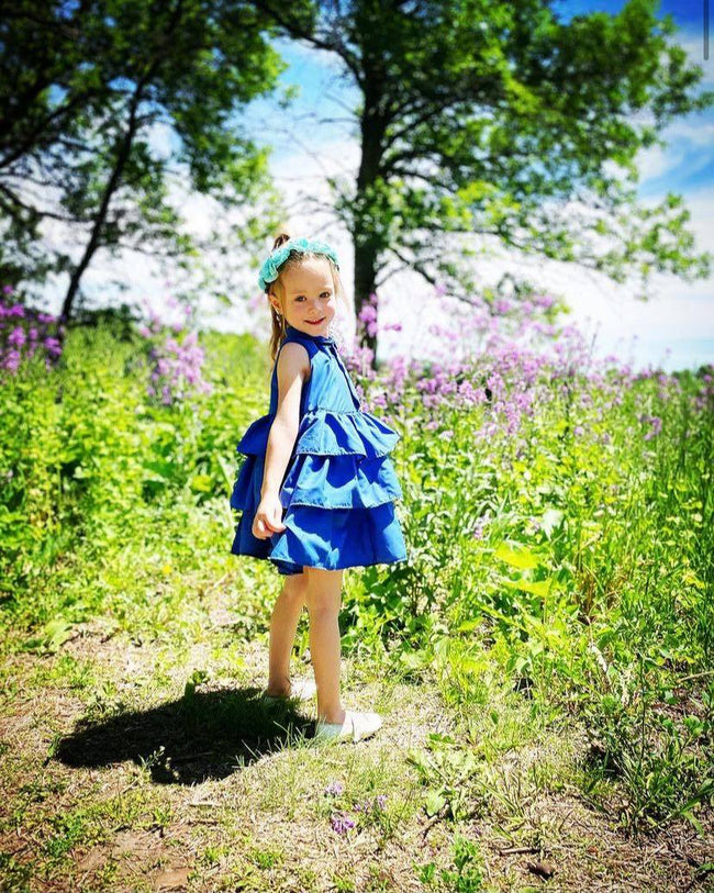 little girl wearing a blue tiered dress