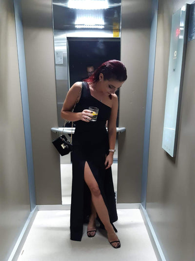 woman in an elevator wearing a diy black cocktail dress pattern