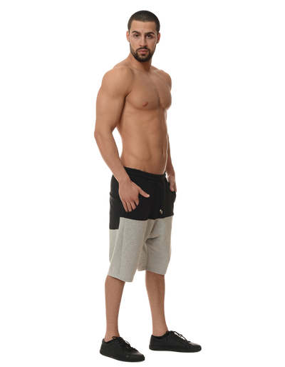 side view of a man posing in a pair of shorts