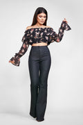 woman posin in a diy sewn off the shoulder crop top pattern and jeans