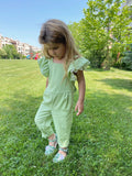girl wearing a green jumpsuit