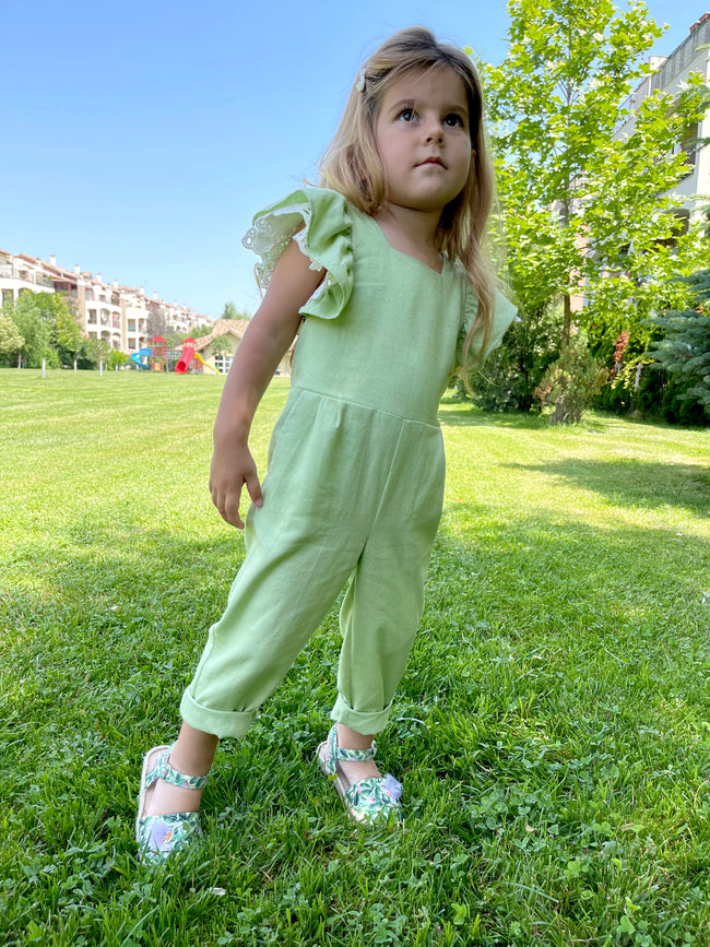 girl in a green pinafore jumpsuit