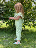 girl in a green jumpsuit