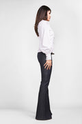 sideview of a woman posing for a long sleeve shirt sewing pattern