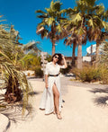 woman on a tropical beach in a white diy sewn maxi shirt dress pattern