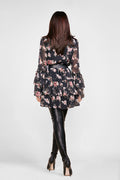 back view of a woman in a floral mini dress pattern