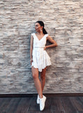 woman standing against a wall in a diy sewn white summer dress patter