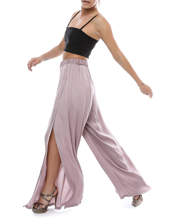 studio shoot of a woman stepping in a lila self sewn pants pattern