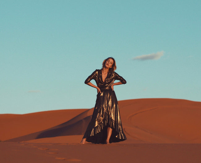 woman posing in the dessert in a maxi dress pattern sewn product
