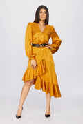 full body studio shoot of a woman in a golden wrap dress pattern